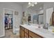 Well-lit bathroom with double sinks and an adjoining walk-in closet at 315 Bulkhead Bend # 315, Carolina Shores, NC 28467