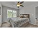 Cozy bedroom with window view, ceiling fan, and comfortable bedding at 315 Bulkhead Bend # 315, Carolina Shores, NC 28467