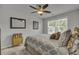 Bright bedroom with a patterned comforter, ceiling fan, and a large window at 315 Bulkhead Bend # 315, Carolina Shores, NC 28467