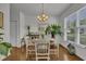 Bright dining room with hardwood floors, stylish chandelier, and large window offering ample natural light at 315 Bulkhead Bend # 315, Carolina Shores, NC 28467