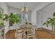 Bright dining room featuring hardwood floors, a stylish chandelier and a large window offering ample natural light at 315 Bulkhead Bend # 315, Carolina Shores, NC 28467
