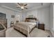 Spacious main bedroom with tray ceilings, neutral decor, and adjoining bathroom entrance at 315 Bulkhead Bend # 315, Carolina Shores, NC 28467