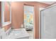 Attached bathroom features a shower and vanity with sink, with a peek at the bedroom through the mirror at 329 54Th Ave. N, North Myrtle Beach, SC 29582