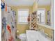 Bathroom features a patterned shower curtain, window, mirror, sink and toilet at 329 54Th Ave. N, North Myrtle Beach, SC 29582