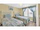 Cozy bedroom with two twin beds, bright yellow walls, and natural light from two large windows at 329 54Th Ave. N, North Myrtle Beach, SC 29582