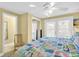 Cozy bedroom with doors to the outside features a ceiling fan and an adjacent bathroom at 329 54Th Ave. N, North Myrtle Beach, SC 29582