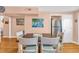 Dining area adjacent to the kitchen features a rustic table, four chairs and beachy decor at 329 54Th Ave. N, North Myrtle Beach, SC 29582