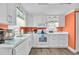 Well-lit kitchen features white cabinetry, modern appliances, and a view of the outdoors from the bright windows at 329 54Th Ave. N, North Myrtle Beach, SC 29582