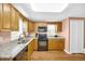 Bright kitchen with wood cabinets, granite counters, black appliances, hardwood floors at 329 54Th Ave. N, North Myrtle Beach, SC 29582