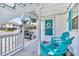 Inviting porch with blue Adirondack chairs and decorative touches for a relaxed outdoor experience at 329 54Th Ave. N, North Myrtle Beach, SC 29582