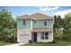Charming two-story home with mint-green siding, a garage, and a well-manicured lawn at 3382 Wood Stork Dr., Ocean Isle Beach, SC 28469