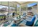 Enjoy pond views from this four-season sunroom with wicker furniture and cool color palette at 408 Capua Ct., Myrtle Beach, SC 29588