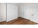 Bedroom featuring hardwood floors, a built-in murphy bed, closet, and neutral paint at 409 Cypress View Ave., Little River, SC 29566