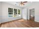 This bedroom features hardwood flooring, a spacious closet, and a view of the pool at 409 Cypress View Ave., Little River, SC 29566