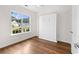 Bedroom featuring hardwood floors, a large window, and a built-in murphy bed at 409 Cypress View Ave., Little River, SC 29566