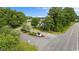 Landscaped neighborhood entrance featuring mature trees, road and signage at 409 Cypress View Ave., Little River, SC 29566