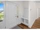 Bright entryway with tile flooring, a storage bench, coat hooks, and natural light streaming through the front door at 409 Cypress View Ave., Little River, SC 29566