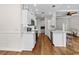 Modern kitchen with white cabinets, stone countertops, stainless steel appliances and lots of lighting at 409 Cypress View Ave., Little River, SC 29566