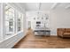 Open-concept living area with hardwood floors, plenty of natural light and kitchen view at 409 Cypress View Ave., Little River, SC 29566