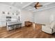 Open-concept living room with hardwood floors, recessed lighting, and a view of the kitchen and the front entryway at 409 Cypress View Ave., Little River, SC 29566