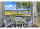 Relaxing screened-in balcony with comfortable seating and scenic waterfront views at 4400 Turtle Ln. # 2-D, Little River, SC 29566