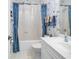 Charming bathroom with sea-themed wallpaper, blue curtains, and a clean white vanity at 4400 Turtle Ln. # 2-D, Little River, SC 29566