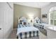 This bedroom has two beds, carpeted floors and a green accent wall at 4400 Turtle Ln. # 2-D, Little River, SC 29566