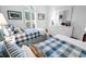 Bright bedroom with two twin beds, white dresser, and arched window allowing natural light at 4400 Turtle Ln. # 2-D, Little River, SC 29566