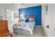 Comfortable bedroom with a blue accent wall, ceiling fan, and a cozy quilt on the bed at 4400 Turtle Ln. # 2-D, Little River, SC 29566