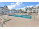 Community pool with plenty of lounge chairs for residents to relax and enjoy the sun at 4400 Turtle Ln. # 2-D, Little River, SC 29566