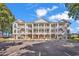 Attractive three-story condominium building featuring private balconies and dedicated parking spaces at 4400 Turtle Ln. # 2-D, Little River, SC 29566