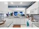 Kitchen featuring white appliances, cabinets, and granite countertops with a view to the blue living room at 4400 Turtle Ln. # 2-D, Little River, SC 29566