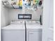 Functional laundry room with a washer, dryer, and shelving for organized storage at 4400 Turtle Ln. # 2-D, Little River, SC 29566