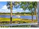 Picturesque water view with a boat gliding along the serene river and lush greenery at 4400 Turtle Ln. # 2-D, Little River, SC 29566