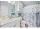 Well-lit bathroom with blue accents, white vanity, and classic fixtures at 4683 Wild Iris Dr. # 103, Myrtle Beach, SC 29577
