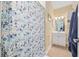 Clean bathroom featuring a patterned shower curtain, tile floors, and a white vanity at 4683 Wild Iris Dr. # 103, Myrtle Beach, SC 29577