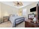 Cozy bedroom with neutral tones, ceiling fan, and ample natural light from window at 4683 Wild Iris Dr. # 103, Myrtle Beach, SC 29577