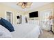 Bright bedroom with white furniture, ceiling fan, carpet, and an open doorway to a walk-in closet at 4683 Wild Iris Dr. # 103, Myrtle Beach, SC 29577