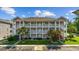 Three story condo complex featuring private balconies, stairwells, and manicured landscaping at 4683 Wild Iris Dr. # 103, Myrtle Beach, SC 29577