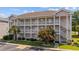 Three story condo complex featuring private balconies, stairwells, and manicured landscaping at 4683 Wild Iris Dr. # 103, Myrtle Beach, SC 29577