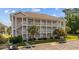Three story condo complex featuring private balconies, stairwells, and manicured landscaping at 4683 Wild Iris Dr. # 103, Myrtle Beach, SC 29577