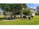 Exterior of condos with grills and picnic table surrounded by lush landscaping at 4683 Wild Iris Dr. # 103, Myrtle Beach, SC 29577