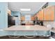 Well-lit kitchen with hardwood cabinets, stainless appliances, and a sleek breakfast bar at 4683 Wild Iris Dr. # 103, Myrtle Beach, SC 29577