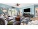 Comfortable living room with a leather couch, large rug, and a sliding glass door to the outside at 4683 Wild Iris Dr. # 103, Myrtle Beach, SC 29577