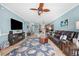Comfortable living room with a leather couch, large rug, and views into the kitchen at 4683 Wild Iris Dr. # 103, Myrtle Beach, SC 29577