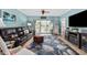 Comfortable living room with a leather couch, large rug, and a sliding glass door to the outside at 4683 Wild Iris Dr. # 103, Myrtle Beach, SC 29577