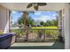 Charming outdoor patio with fan, lush landscaping, and views of grassy area with community amenities at 4683 Wild Iris Dr. # 103, Myrtle Beach, SC 29577