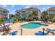 Outdoor pool surrounded by lounge chairs and lush greenery near condos at 4683 Wild Iris Dr. # 103, Myrtle Beach, SC 29577