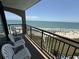 Enjoy breathtaking ocean views from this cozy balcony with comfortable seating, perfect for relaxation and serenity at 4800 S Ocean Blvd. # 706, North Myrtle Beach, SC 29582