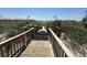 Access to a sandy beach with green grass and showers to clean off the sand at 4800 S Ocean Blvd. # 706, North Myrtle Beach, SC 29582